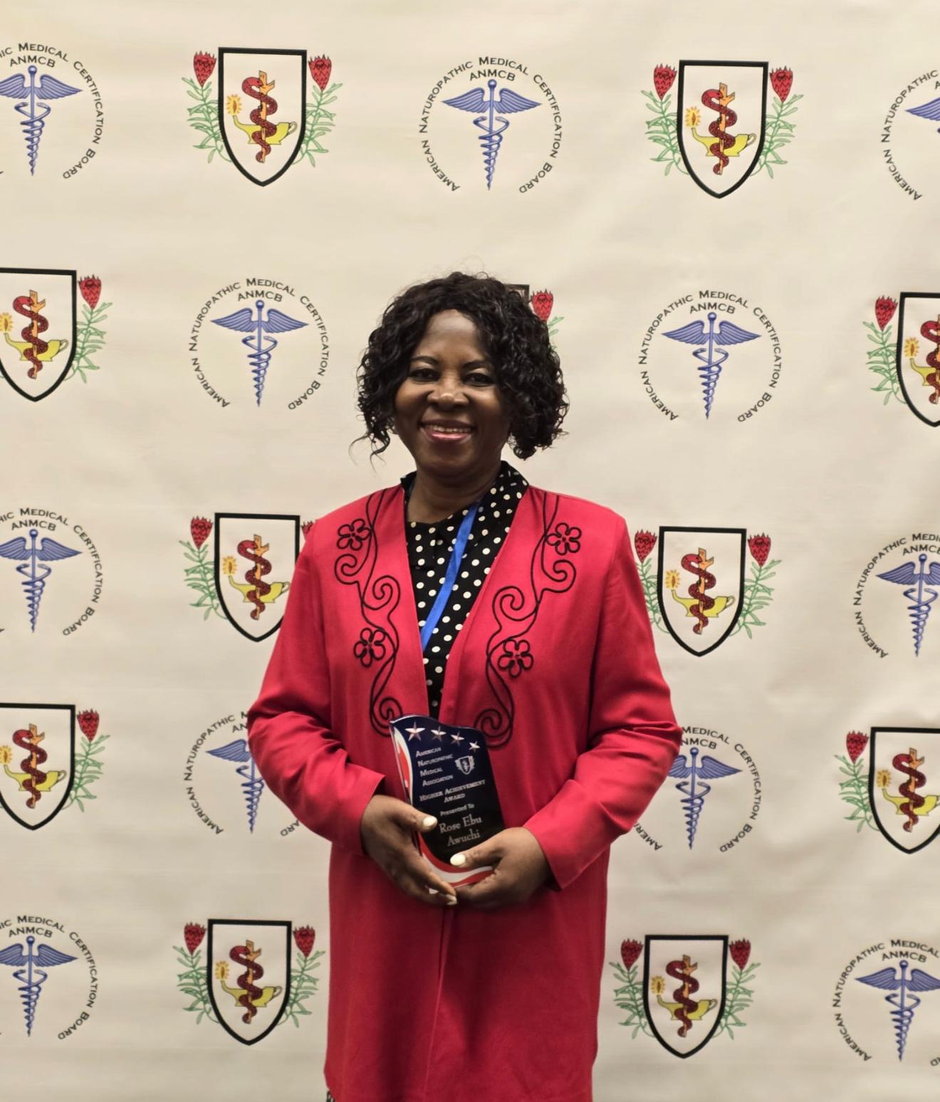 Dr. Rose Ebu Awuchi holding the American Naturopathic Medical Association Higher Achievement Award